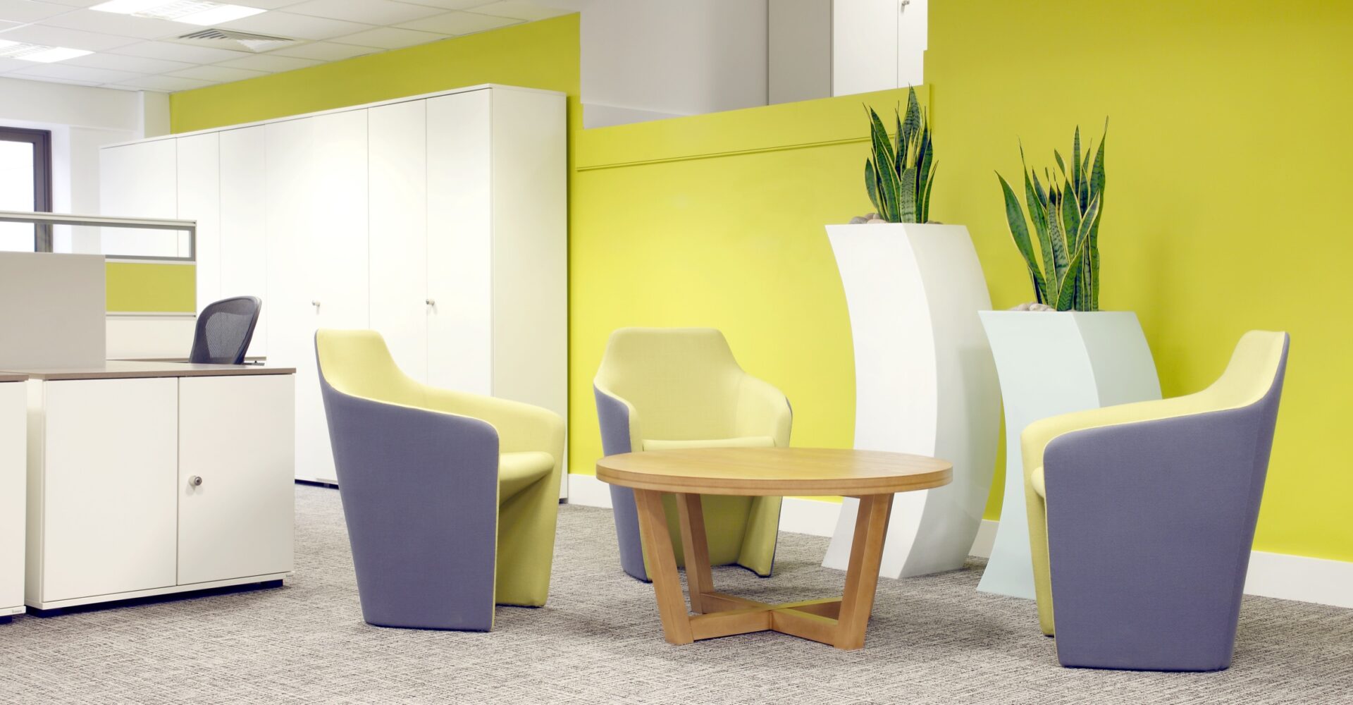Breakout seating against a yellow wall