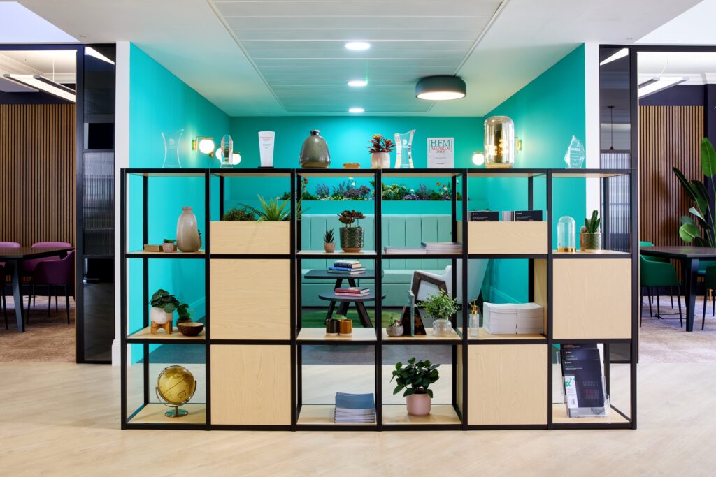 Open shelving against a teal wall